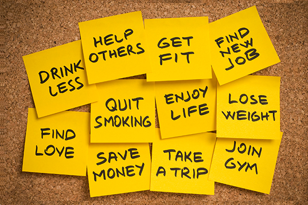 Cork Board with Yellow Post-Its Lists New Year's Resolutions