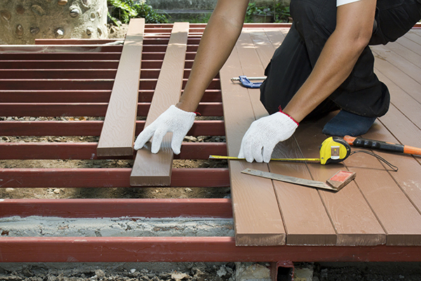 Someone Installing a Wooden Deck in Home