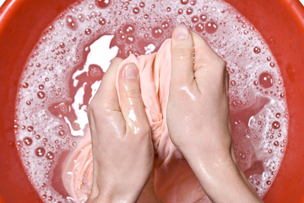 Someone Ringing a Rag Inside a Soapy Water Bucket