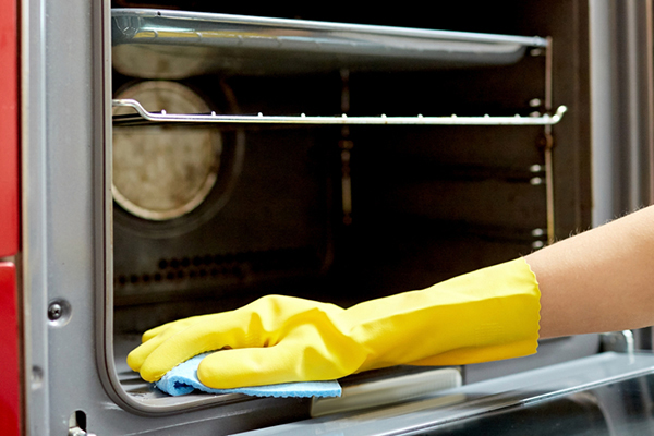 Someone Cleaning Oven with Natural Products