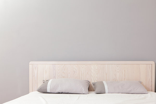 Neautral Bed Frame and Bed in Front of Gray Wall